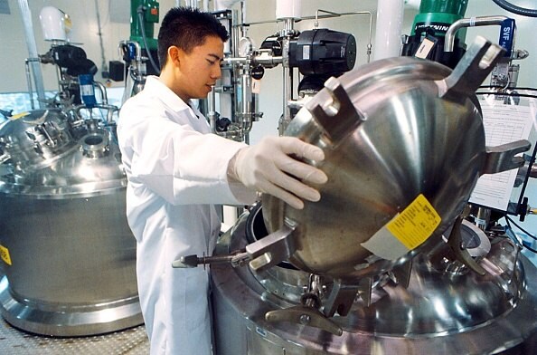 Worker loading upstream chemicals for bioprocessing