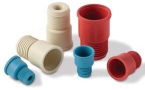 Septa An array of six Suba-seal septa in red, blue, and beige, featuring various sizes and shapes, scattered on a white background, with ridges for grip or attachment.