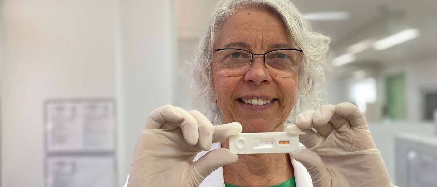Samira Bührer Dr. Samira Bührer wears glasses, gloves and holds up a rapid test for Hansen’s disease. ------------