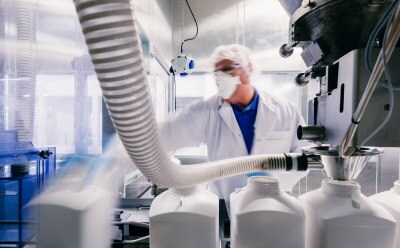 Process engineer checking the filling system in production area