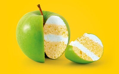 Cut apple with a slice showing cake to illustrate food fraud